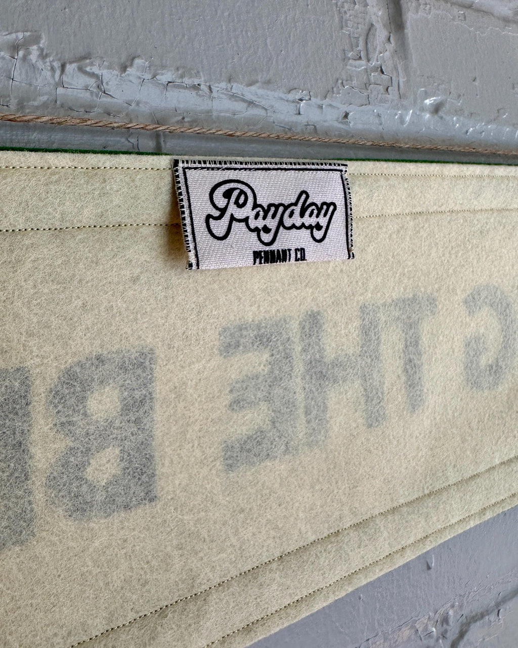 Close up of the back of a cream banner with black trim and lettering that reads "I'm doing the best at this"