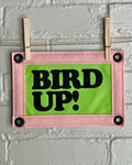 Bright green felt banner with light pink trim, and black lettering that reads "Bird up!"