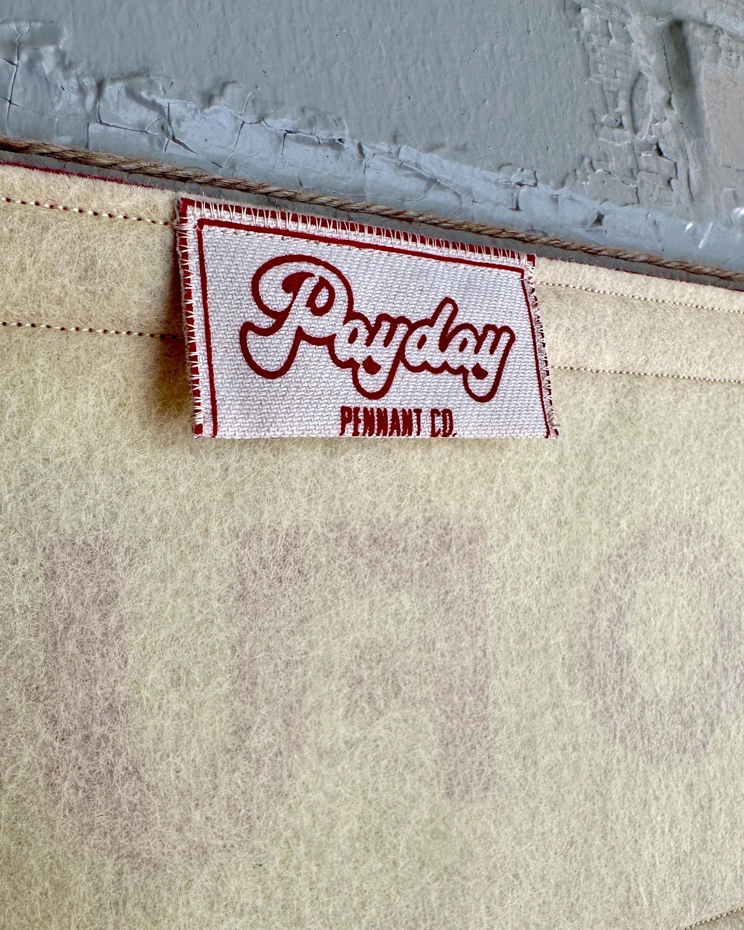 Close-up of a 'Payday Pennant Co.' label printed in red ink on a felt banner