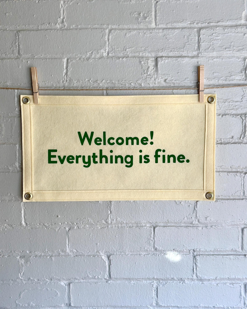 Cream felt banner with green lettering referencing The Good Place reading "Welcome! Everything is fine."