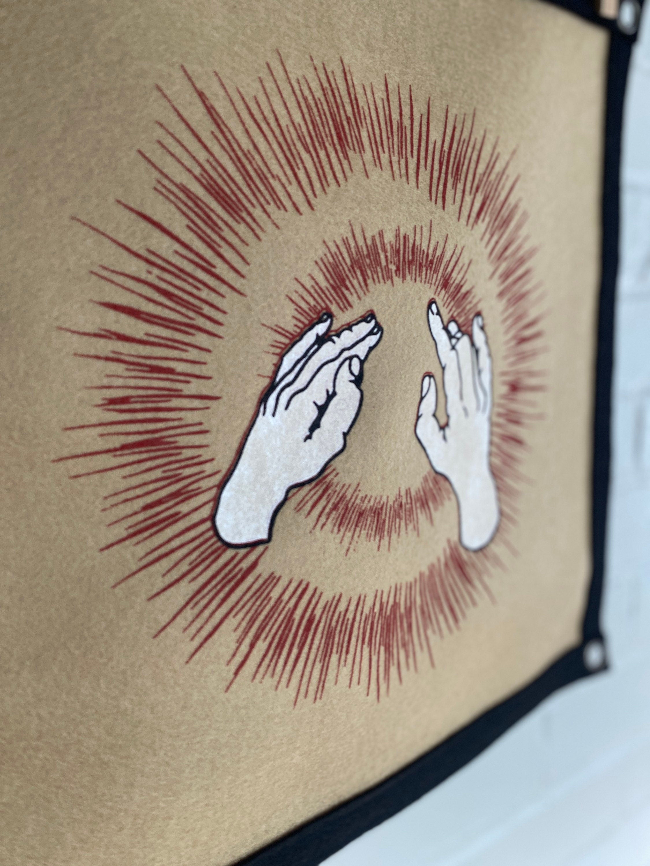 Closeup view of a light brown felt banner with black trim, and album art from band Godspeed You! Black Emperor