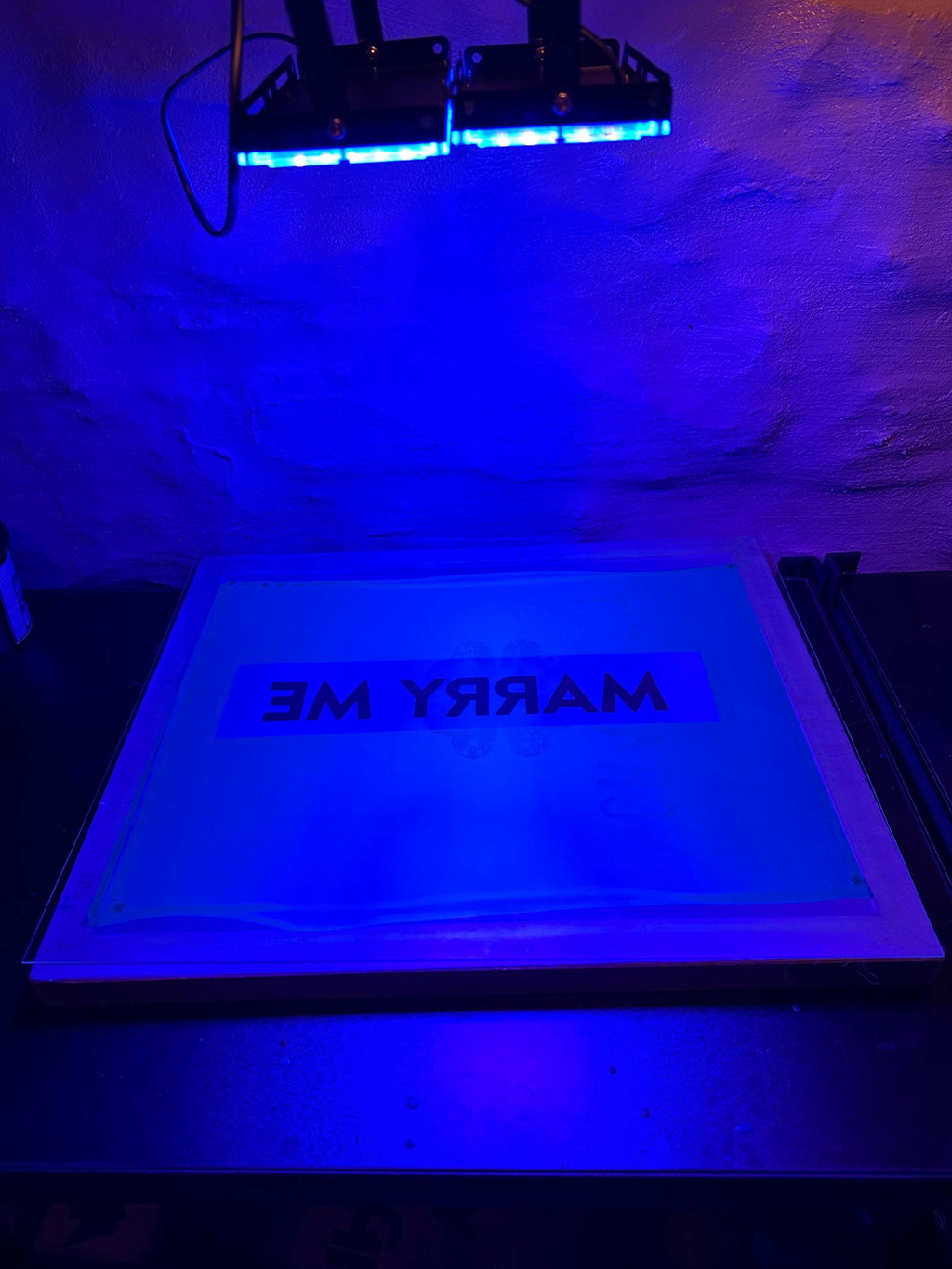 Ultraviolet light exposure device with 'MARRY ME' text on a silkscreen.