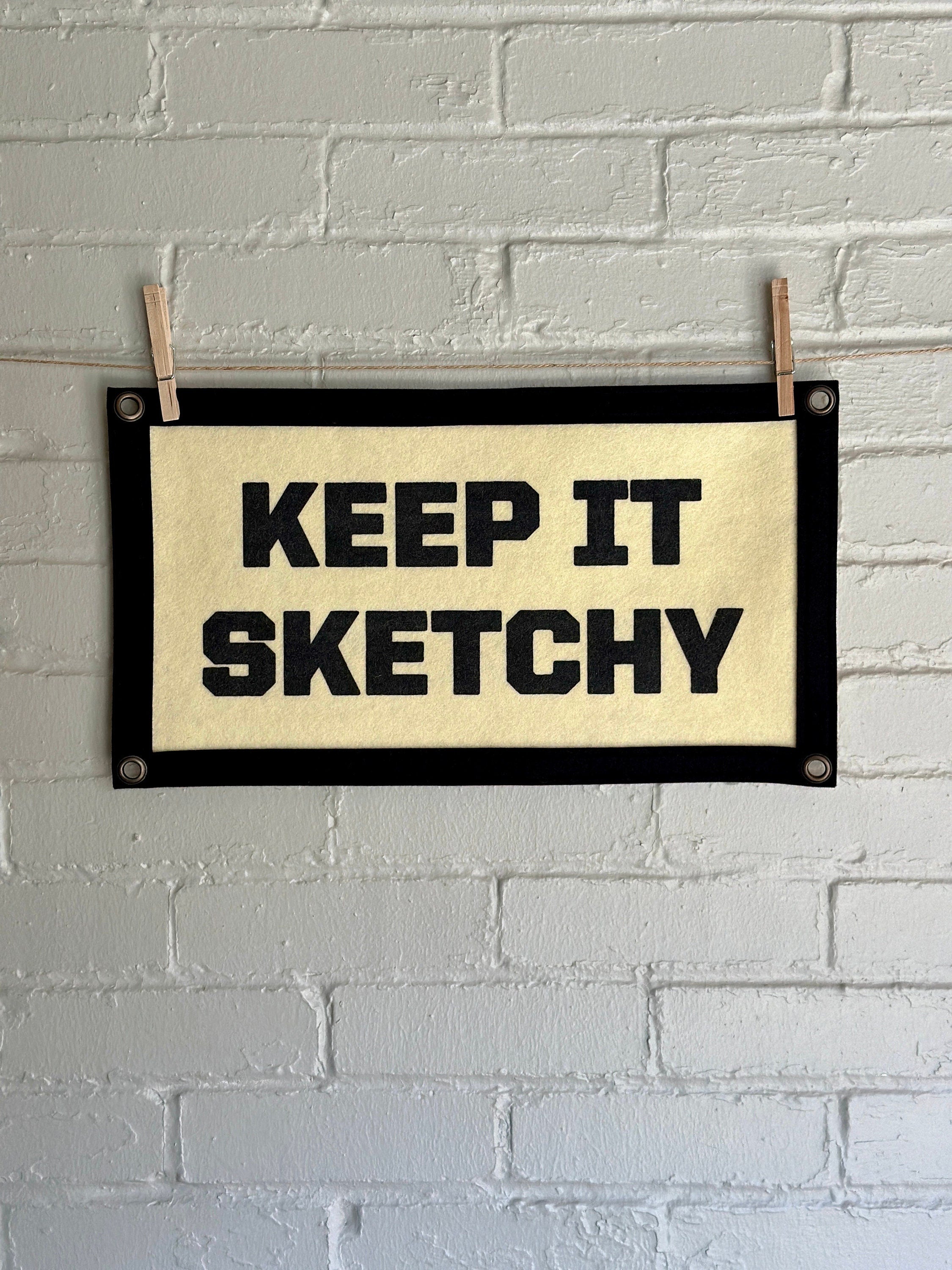 A cream banner with black trim and lettering that reads "Keep it Sketchy"