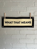 A cream banner with black trim and text that reads "WHAT THAT MEANS"