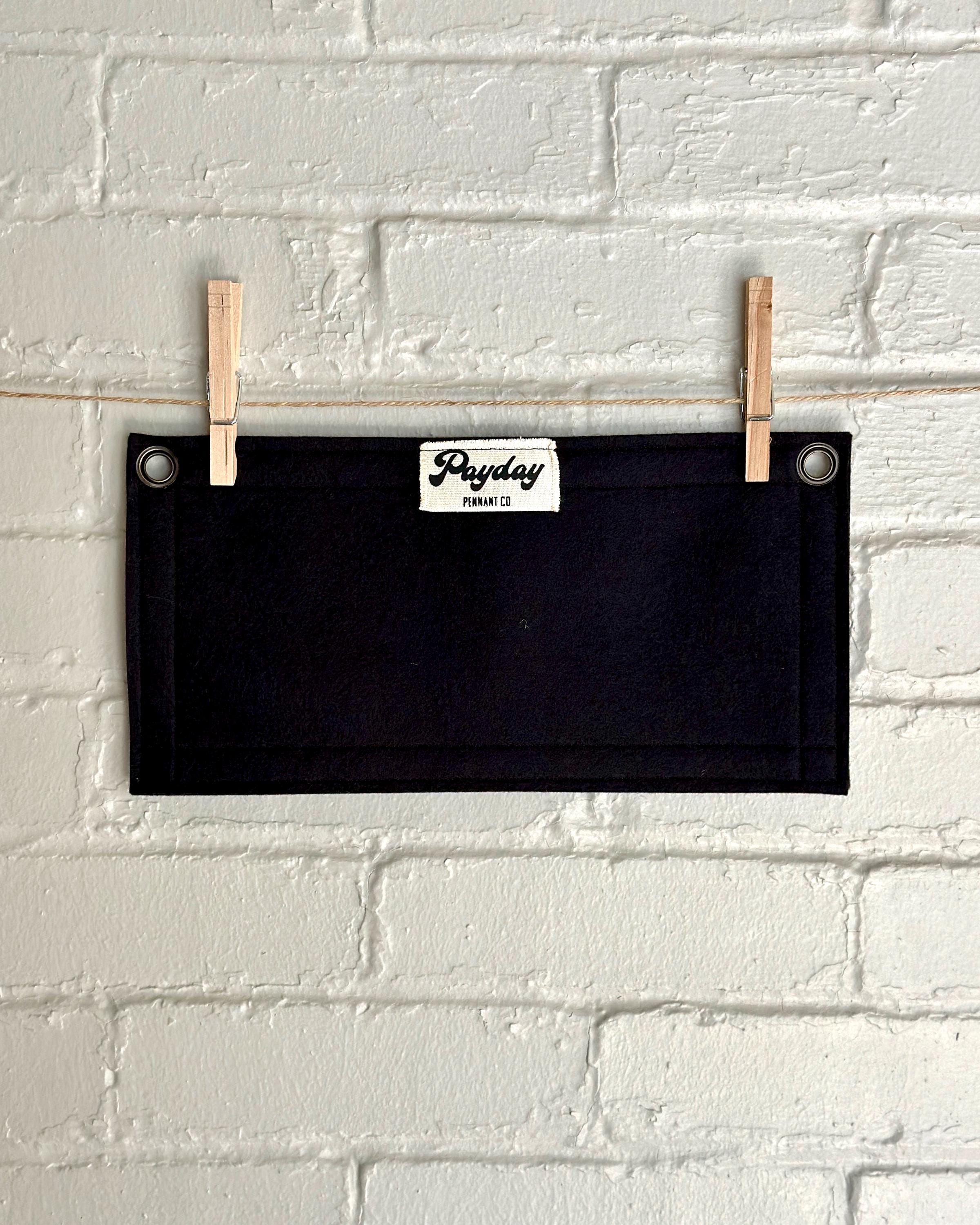 Back of a black felt banner with black trim and red lettering that reads 'YOU DIED'