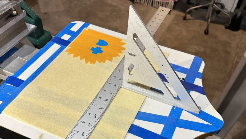 The BCBS banner being registered on a screen printing platen.