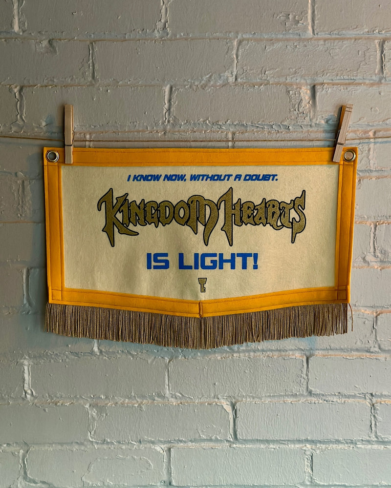 A pentagonal felt banner with yellow trim and Kingdom Hearts details printed on it.