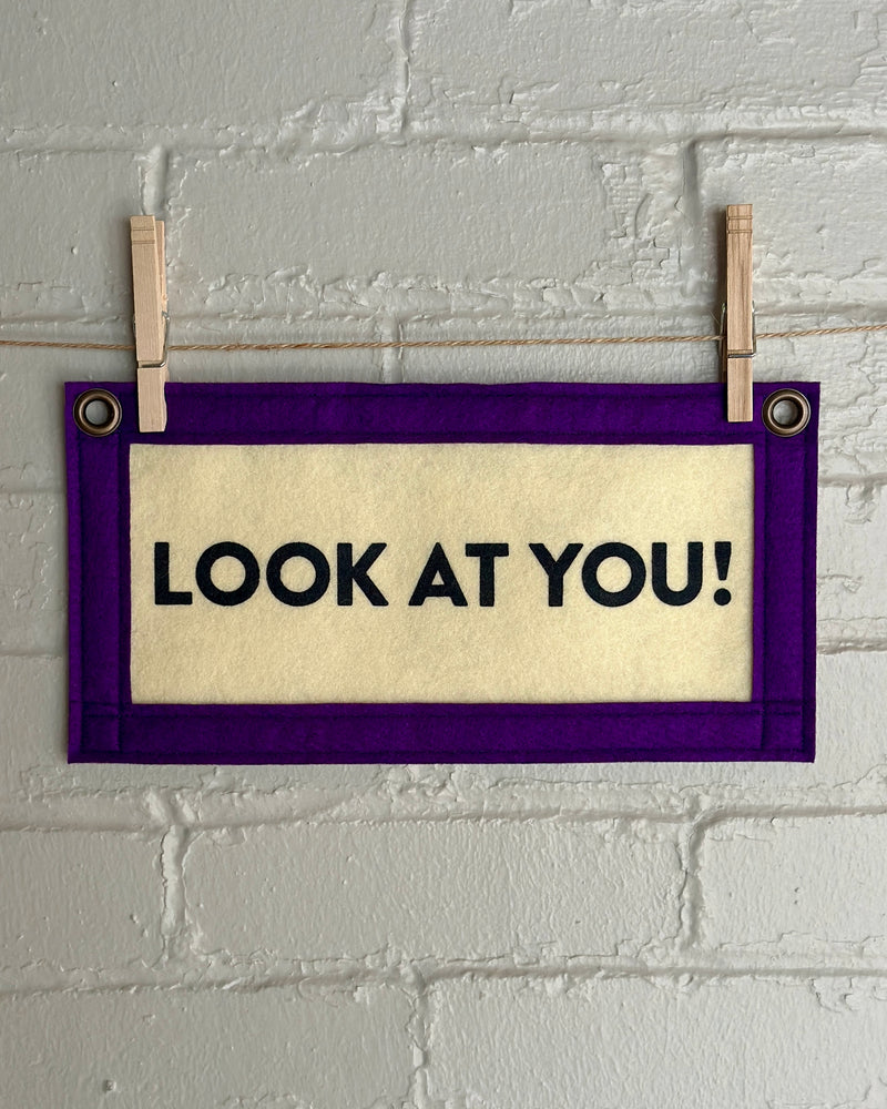 Cream banner with purple trim that reads "Look at you!"