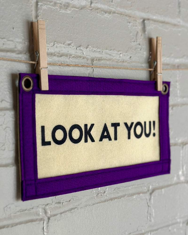 Cream banner with purple trim that reads "Look at you!"