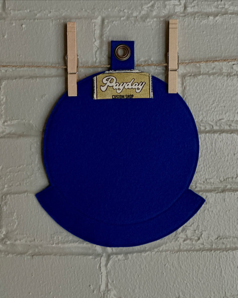 The back of a custom blue squadron emblem showing the Payday Custom Shop tag