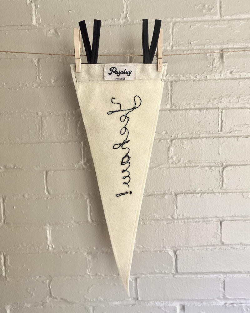 The back of a white pennant with "yeehaw" chain stitched in.