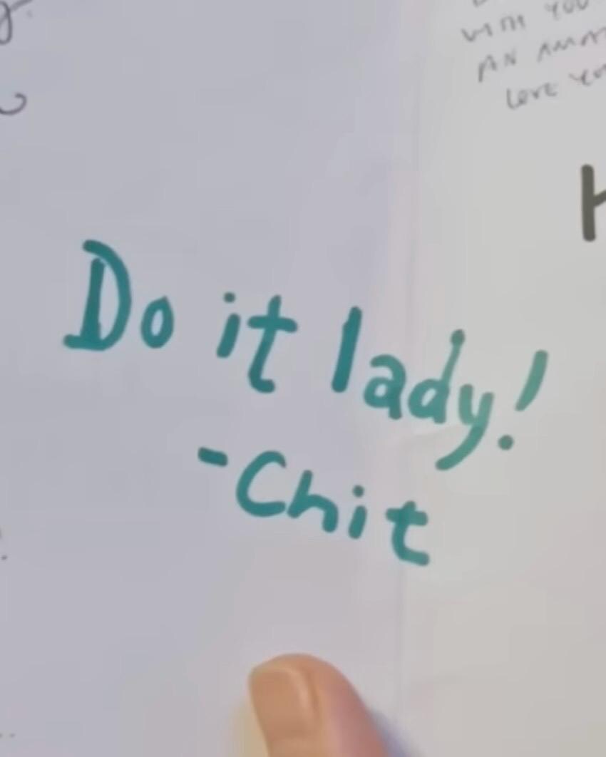 Handwritten text on a card with 'Do it lady! - Chit' in green.