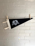 A black pennant with white trim and the Venture Bros "Black Hearts" logo printed on