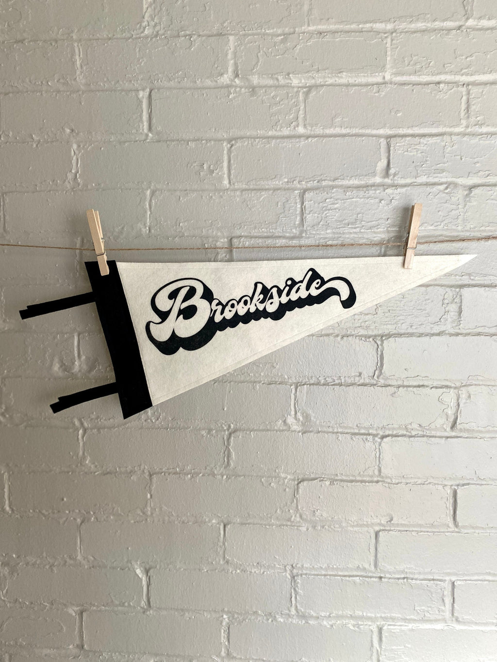 A black and white pennant and "Brookside" printed on