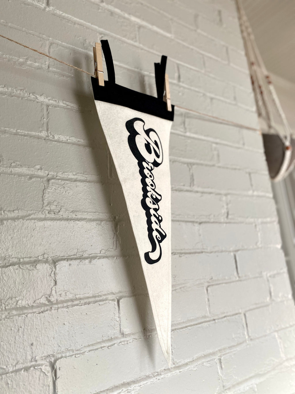 A side view of a black and white pennant and "Brookside" printed on