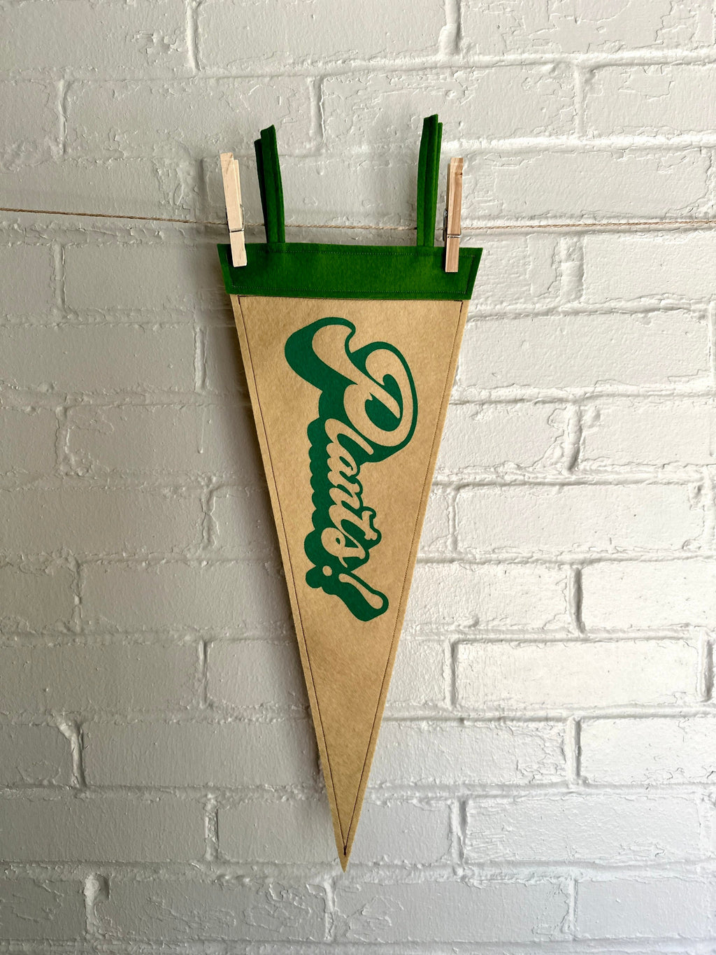 A light brown felt pennant with green trim and green lettering that reads "Plants!"