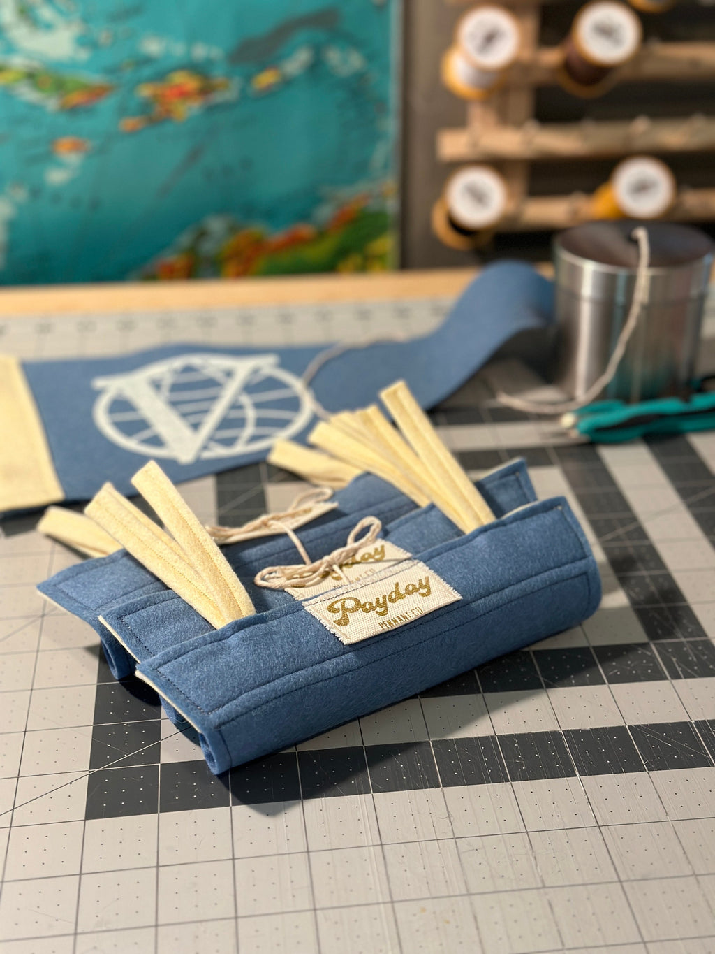 A number of Venture Brothers pennants both rolled up and laid out on a cutting mat